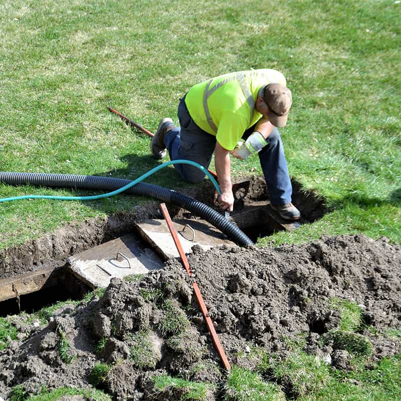 Technician installing residential septic system in Charlotte, NC